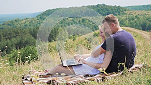 A happy couple using laptop