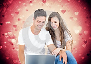 Happy couple using laptop