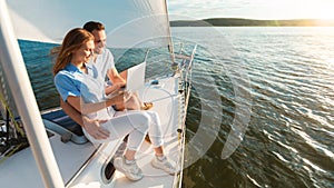 Happy Couple Using Laptop Sitting On Yacht, Panorama