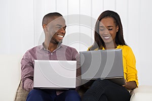 Happy Couple Using Laptops photo