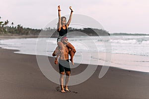 Happy couple on vacation. Lovers on the coast. Man and woman are resting on the sea. Beautiful couple have fun at the sea.