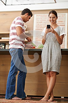 Happy couple, vegetables and phone in kitchen for online research, ebook and nutrition in house. Man, woman and