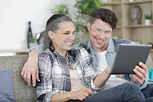 happy couple video chatting on tablet