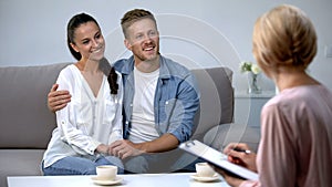 Happy couple visiting psychologist, positive effect of psychotherapy, result