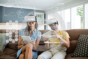 Happy couple in VR headsets looking at interface