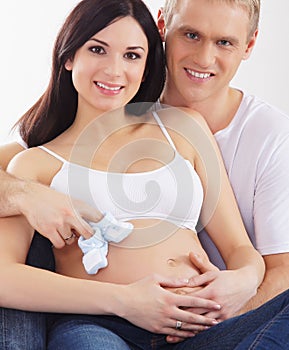 A happy couple waiting for the baby in white clothes