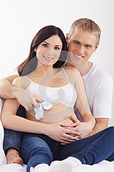 A happy couple waiting for the baby in white clothes