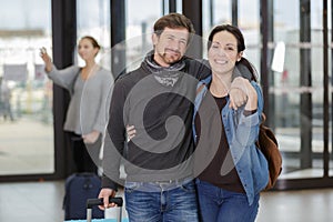 Happy couple waiting for hotel elevator or lift