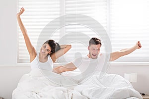 Happy Couple Waking Up On Bed