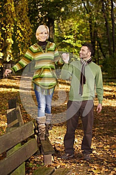 Happy couple walking in autumn park