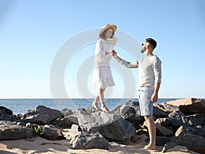 Happy couple walking at beach. Honeymoon trip