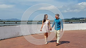 Happy couple walking in hand outdoors