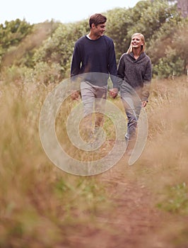 Happy couple, walking or holding hands in the countryside, nature or summer outdoor for hiking on valentines day date