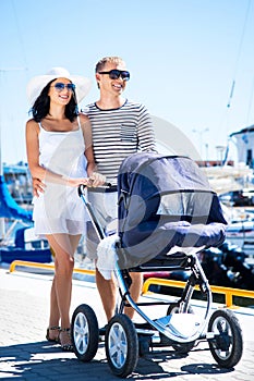 Happy couple walking with their baby