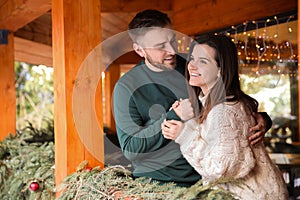 Happy couple in warm clothes on open terrace. Winter