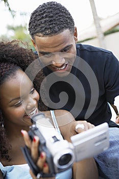 Happy Couple Watching A Camcorder