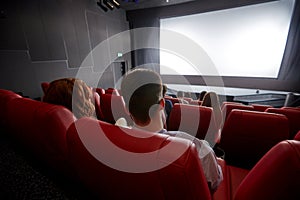 Happy couple watching movie in theater or cinema