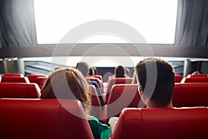 Happy couple watching movie in theater or cinema