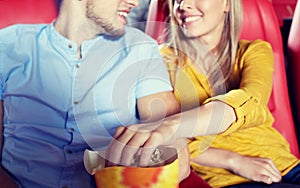 Happy couple watching movie in theater or cinema