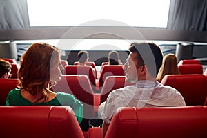 Happy couple watching movie in theater or cinema