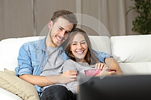 Happy couple watching movie on tv photo
