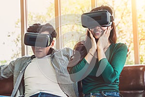 Happy couple watching video in virtual reality VR