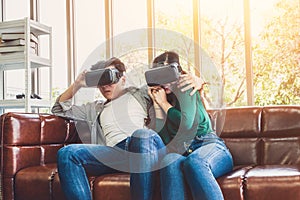 Happy couple watching video in virtual reality VR