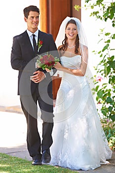 Happy couple, wedding and holding hands with roses for marriage, love or outdoor commitment together. Married bride and