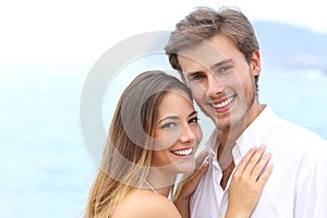 Happy couple with a white smile looking at camera photo