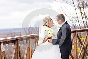 Happy couple in winter or autumn wedding day