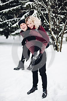 Happy couple in winter forest.