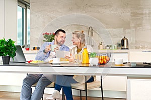 Happy couple working from home and having breakfast together. Breakfast together before leaving for work.