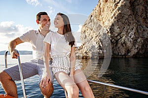 Happy couple on a yacht in summer on romantic vacation