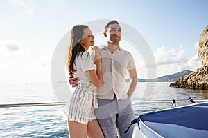 Happy couple on a yacht in summer on romantic vacation