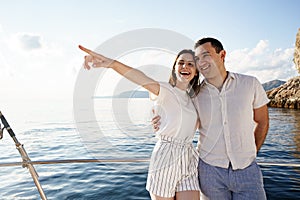 Happy couple on a yacht in summer on romantic vacation