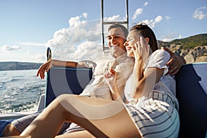 Happy couple on a yacht in summer on romantic vacation