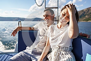 Happy couple on a yacht in summer on romantic vacation