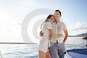 Happy couple on a yacht in summer on romantic vacation