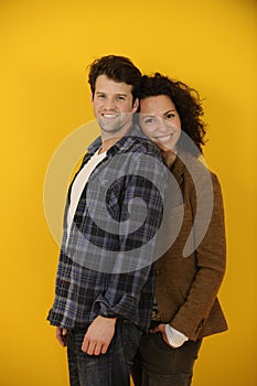 Happy couple on yellow background