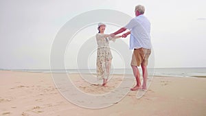 Happy couples holding hands together on the beach