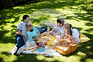 Happy couples interacting while having a glasses of wine