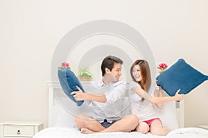 Happy couples smile and playing on bed at home