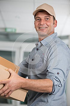happy courier man with holding boxes