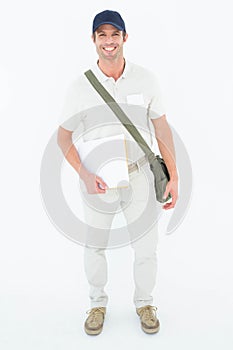 Happy courier man holding envelops