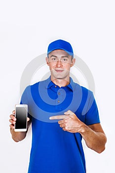 Happy courier with phone. looking at camera. isolated gray background. Studio shoot