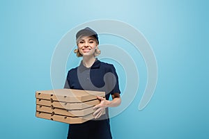 happy courier in uniform holding pizza