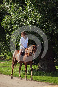 Happy cowgirl on brown horse
