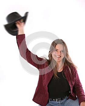 Happy cowgirl waving hat