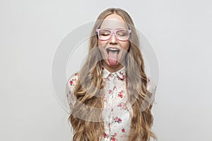 Happy and crazy concept. Teenager girl closed eyes and showing t