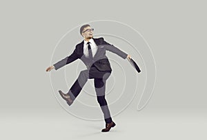 Happy, crazy, funny corporate employee or businessman in suit running home from work